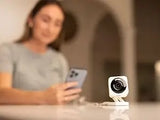 Alt Tag: Wyze Cam v4 2K HD WiFi Security Camer on table with user controlling via smartphone, indoor 2K HD WiFi security camera