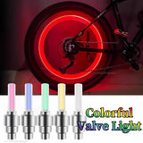 Motion Sensor LED Bike tire valve lights glowing red on bicycle wheel with colorful valve light set for safer night riding